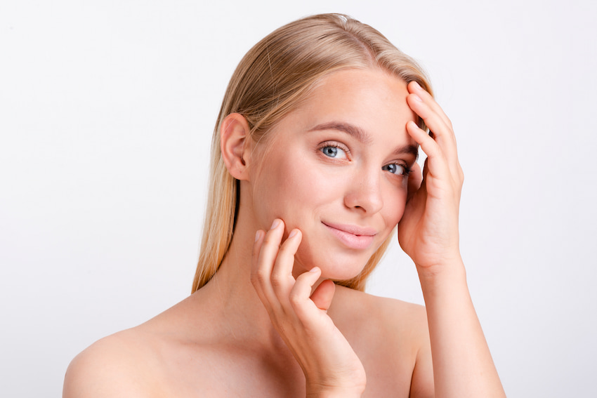 Blonde woman posing with white background